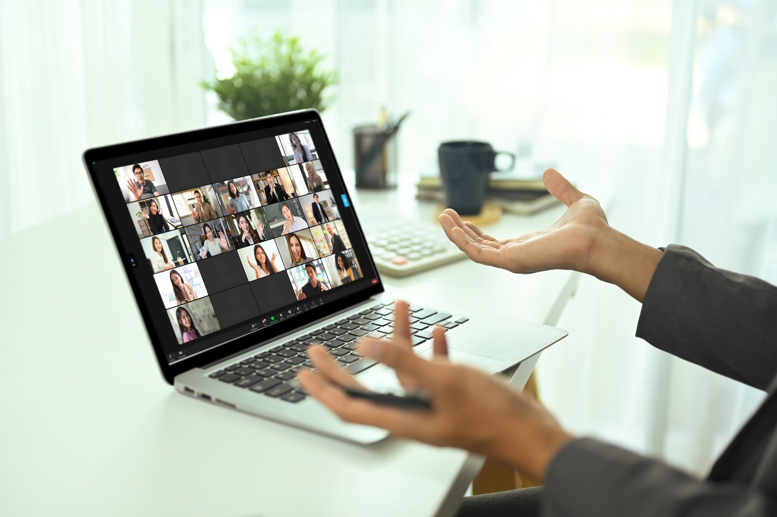 Close up of businessman participating in online team meeting via video chat