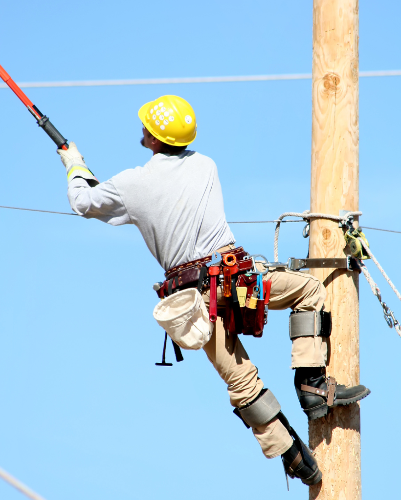 lineman working with medium voltage power distribution equipment